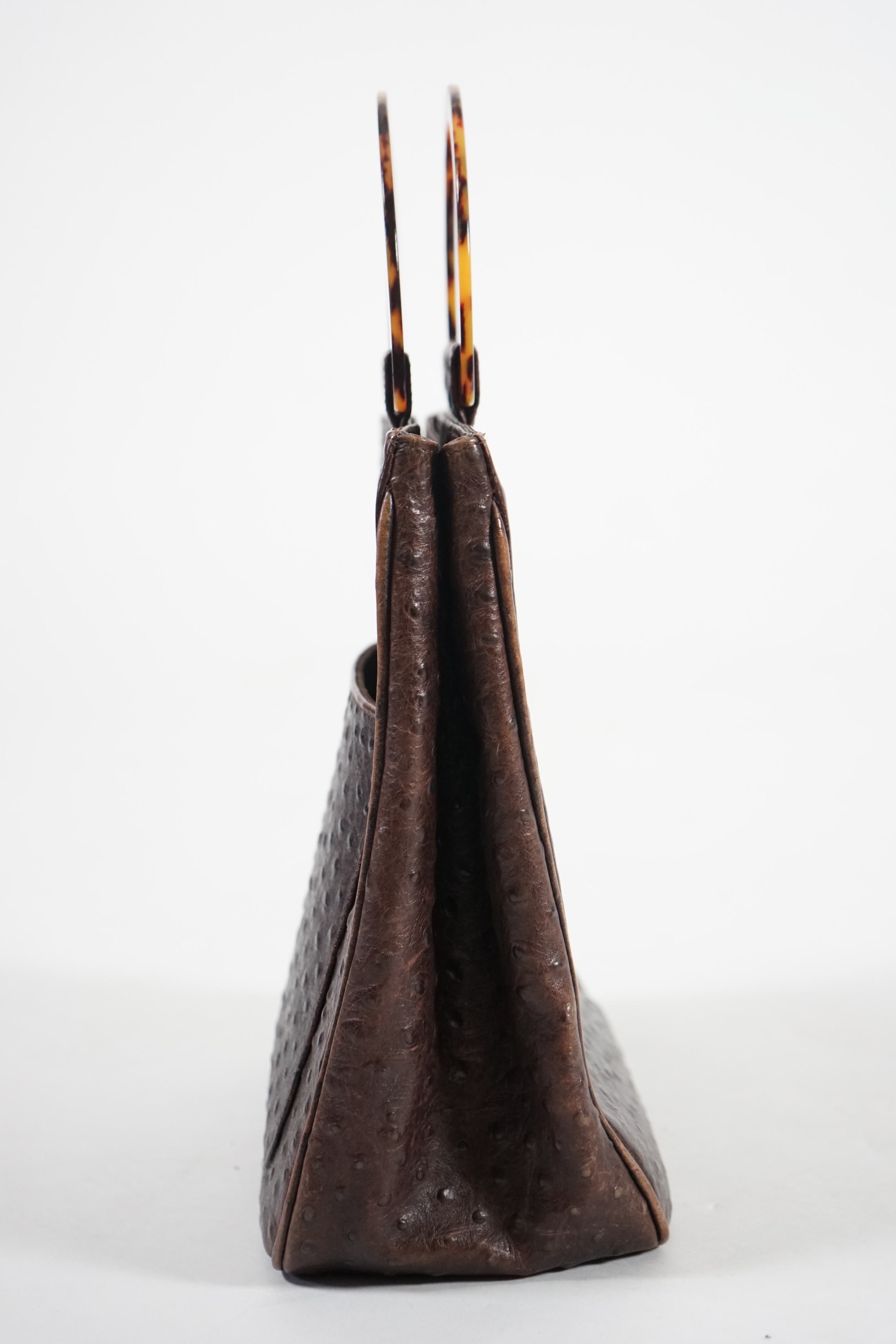 A brown Yves Saint Laurent handbag with faux tortoiseshell handles, ostrich leather with interior zip pocket